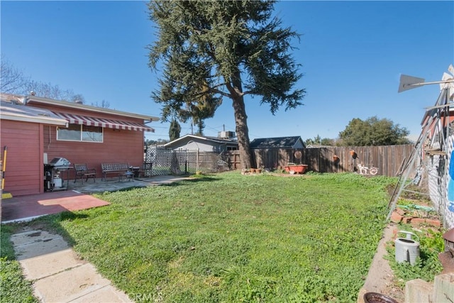 view of yard with a patio area and a fenced backyard