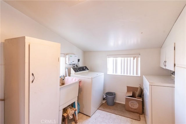 laundry area with light floors, washer and clothes dryer, a sink, and cabinet space