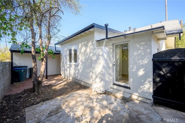 rear view of house featuring a patio area and fence