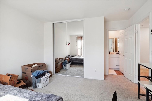 bedroom featuring light carpet and a closet