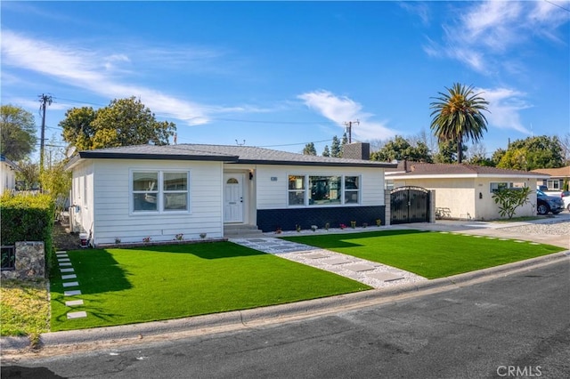 single story home featuring a chimney, a front yard, and a gate