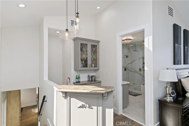 interior space with recessed lighting, wood finished floors, visible vents, baseboards, and pendant lighting