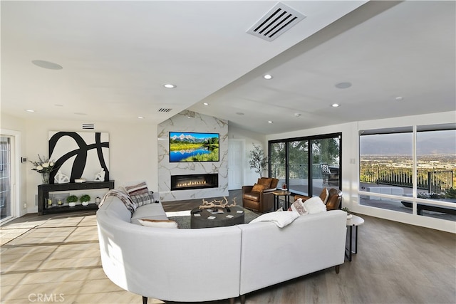 living area featuring a fireplace, visible vents, and recessed lighting