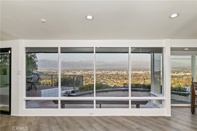 doorway featuring recessed lighting, a mountain view, and wood finished floors