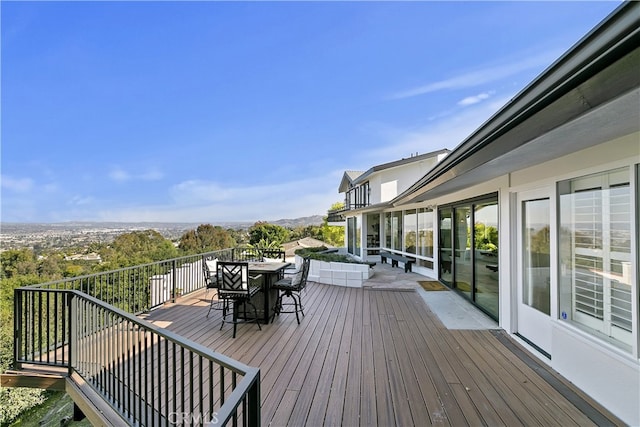 wooden terrace with outdoor dining area