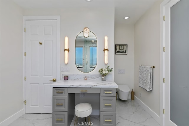 bathroom featuring marble finish floor, toilet, vanity, and baseboards