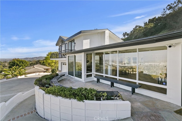 back of property with a balcony