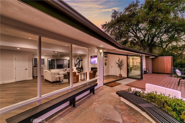 deck at dusk featuring an outdoor hangout area