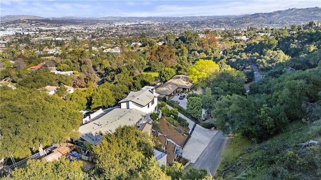 birds eye view of property with a view of trees