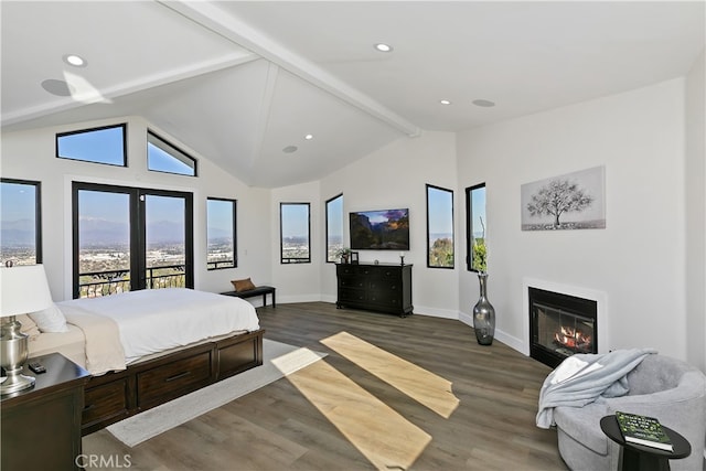 bedroom featuring vaulted ceiling with beams, multiple windows, wood finished floors, and access to exterior