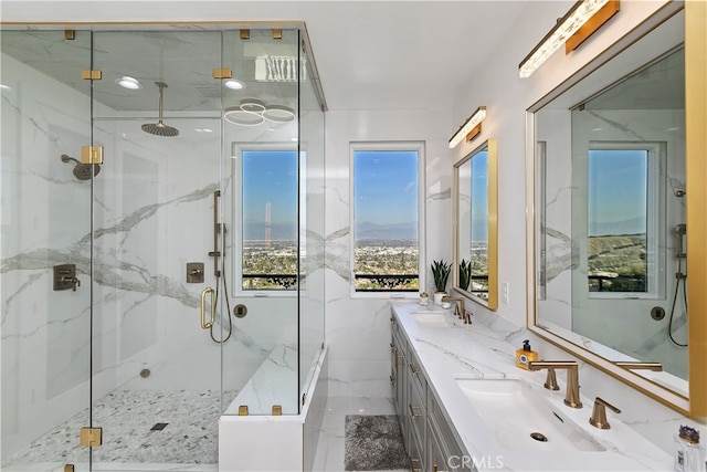 full bath featuring a sink, a marble finish shower, and double vanity