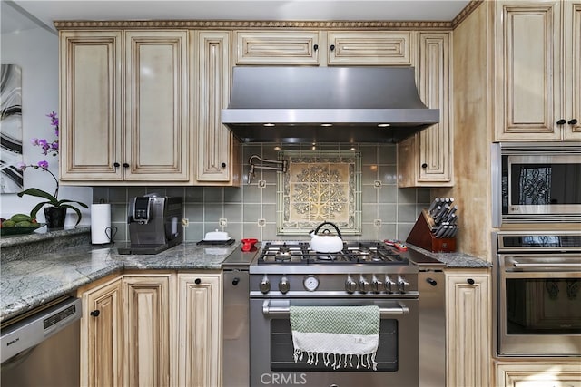 kitchen featuring dark stone counters, ventilation hood, backsplash, and appliances with stainless steel finishes