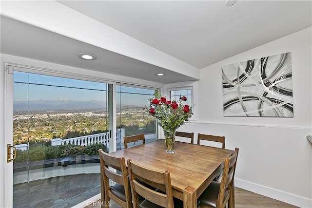 dining space featuring recessed lighting, baseboards, and wood finished floors