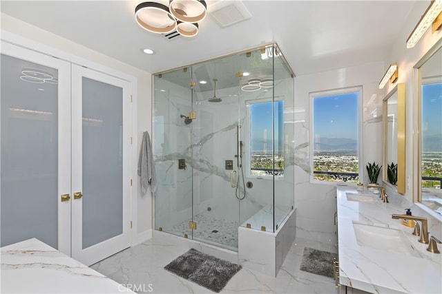 bathroom with marble finish floor, a marble finish shower, a sink, and french doors