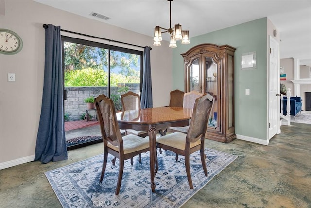 dining space featuring concrete floors, a tiled fireplace, visible vents, and a notable chandelier