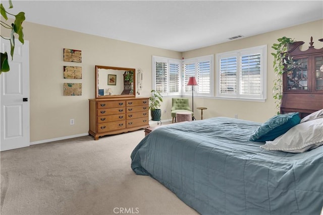 bedroom featuring light carpet, baseboards, and visible vents