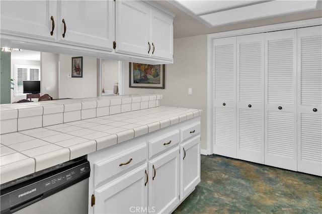 kitchen with tile countertops, concrete flooring, white cabinets, open floor plan, and dishwasher