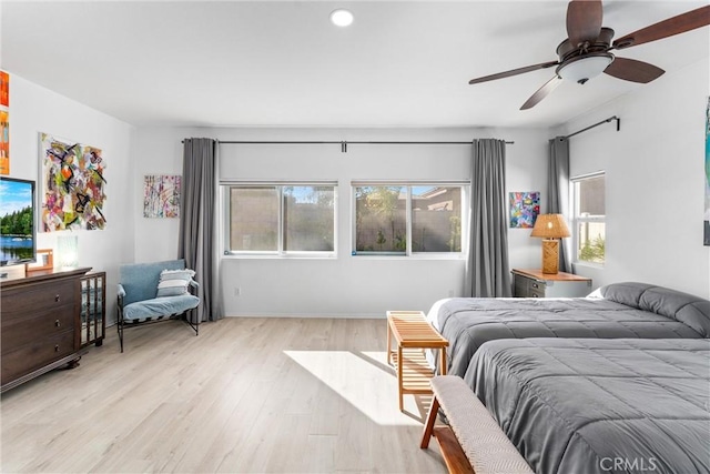 bedroom with a ceiling fan and light wood-style flooring