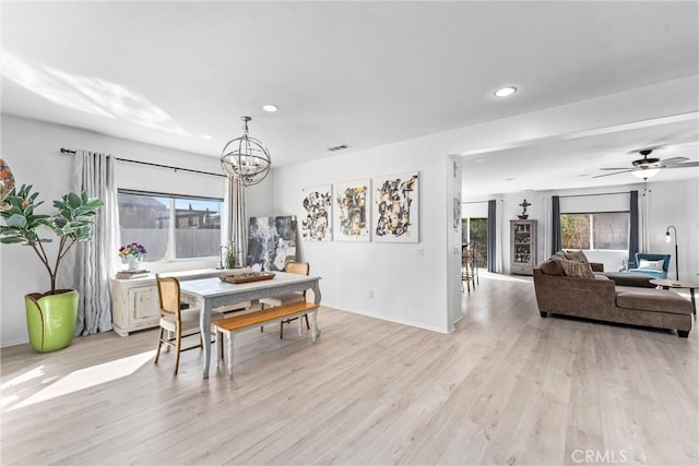 dining room featuring recessed lighting, plenty of natural light, light wood-style flooring, and ceiling fan with notable chandelier