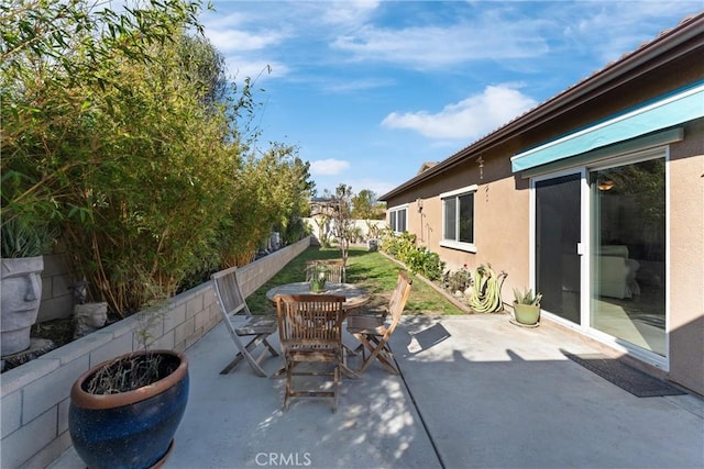 view of patio featuring a fenced backyard and outdoor dining area