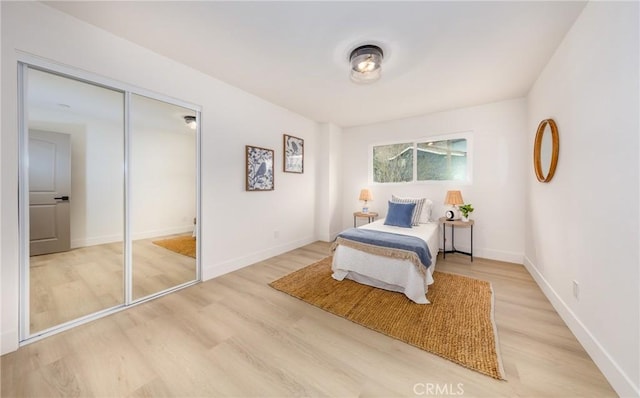 bedroom featuring light wood-type flooring and baseboards