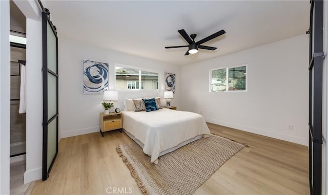 bedroom featuring baseboards, a ceiling fan, and light wood-style floors