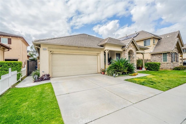 view of front of house featuring a front lawn, fence, stone siding, and stucco siding