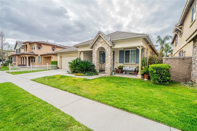 view of front facade with a front lawn, stone siding, fence, concrete driveway, and a garage