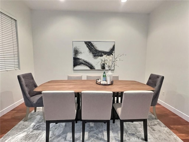 dining room with recessed lighting, baseboards, and wood finished floors