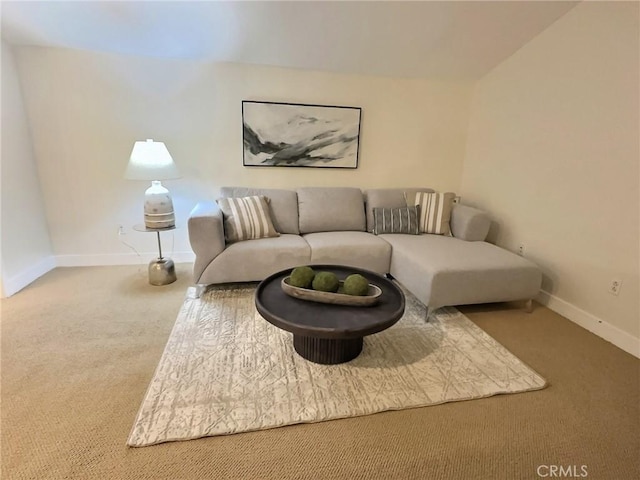 carpeted living area featuring baseboards