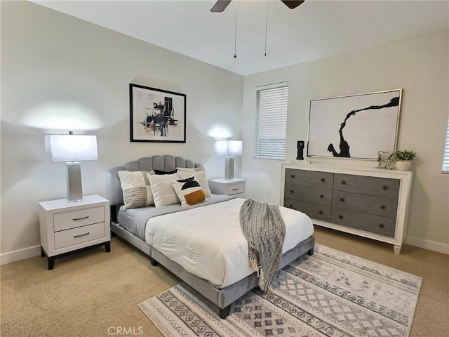 bedroom featuring baseboards, light colored carpet, and ceiling fan