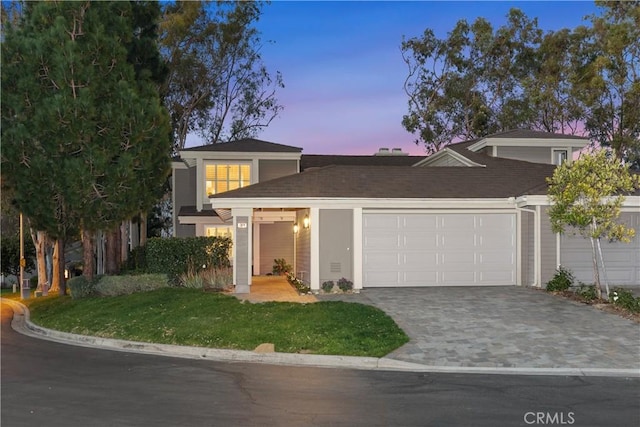 view of front of home featuring decorative driveway and an attached garage