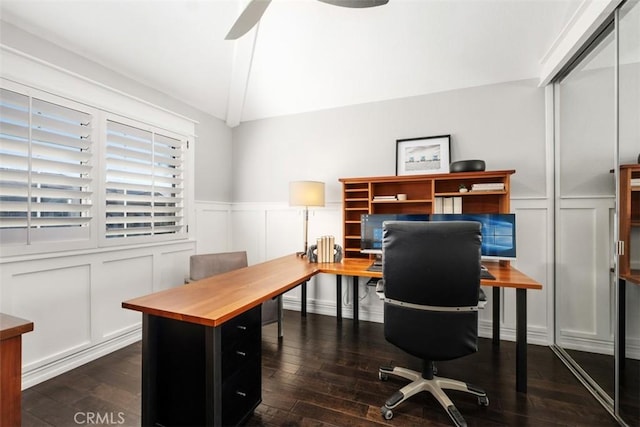 office area featuring dark wood-style floors, a wainscoted wall, lofted ceiling, a decorative wall, and ceiling fan