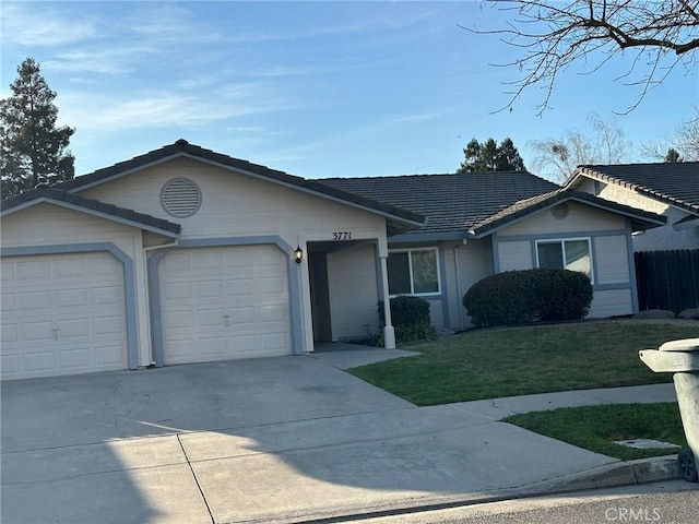 ranch-style house with a garage, a front yard, a tile roof, and driveway