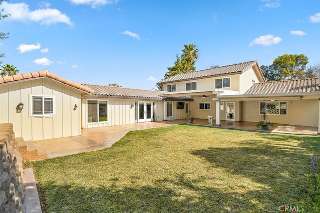 5605 Via, San Jacinto, Riverside, CA 92506 - back of property with a patio, french doors, board and batten siding, a tile roof, and a yard