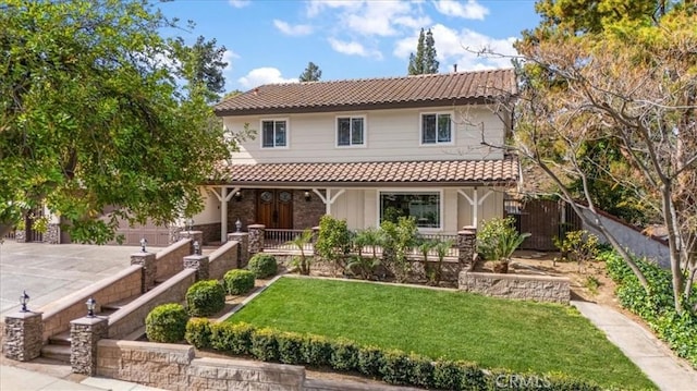 5605 Via, San Jacinto, Riverside, CA 92506 - view of front of property with a tile roof, fence, a front yard, and covered porch