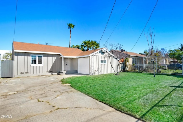 view of front of home with driveway, a front lawn, and board and batten siding