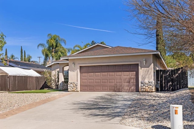 single story home featuring concrete driveway, an attached garage, fence, and stucco siding