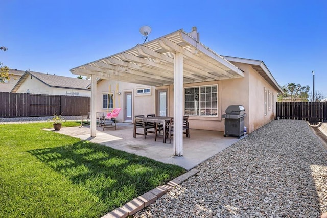 back of property with stucco siding, a fenced backyard, a lawn, and a pergola