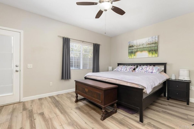 bedroom featuring a ceiling fan, baseboards, and light wood finished floors