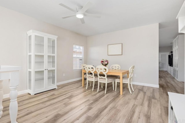 dining space with ceiling fan, light wood-type flooring, and baseboards