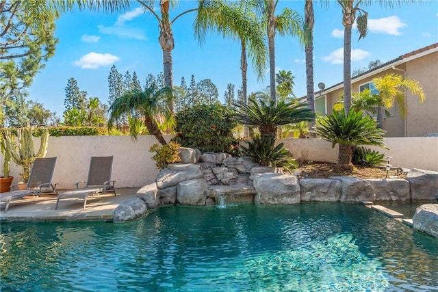 view of swimming pool featuring fence, a fenced in pool, and a patio