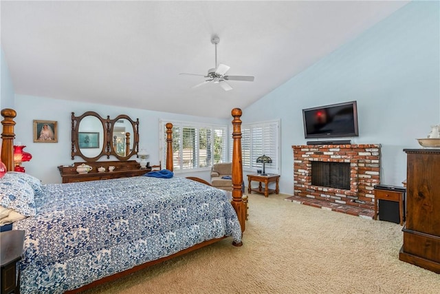 bedroom with carpet floors, ceiling fan, a fireplace, and vaulted ceiling