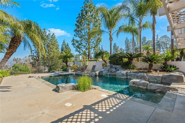 view of pool with a patio area, a jacuzzi, fence, and a fenced in pool