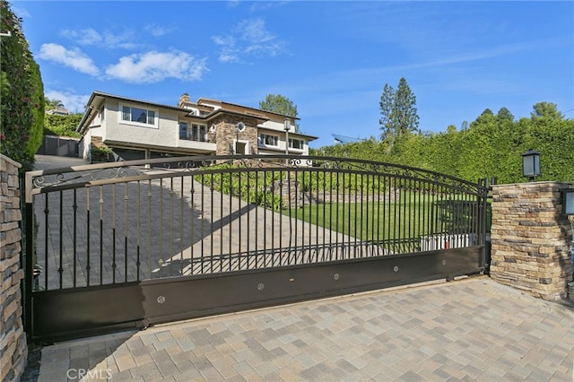 view of gate with a yard