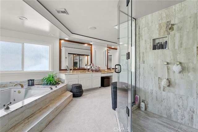 bathroom featuring a whirlpool tub, a stall shower, vanity, and visible vents