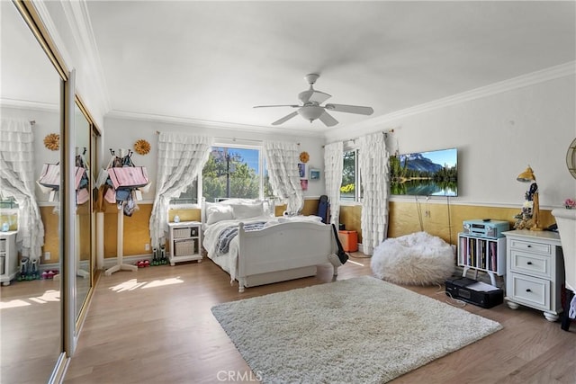 bedroom featuring a closet, wood finished floors, and crown molding