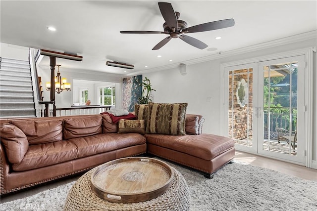 living room featuring ceiling fan with notable chandelier, crown molding, and recessed lighting