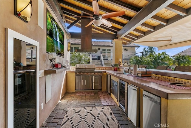 view of patio with exterior kitchen, wine cooler, ceiling fan, and a sink