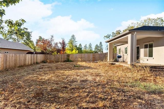 view of yard with a patio area and a fenced backyard